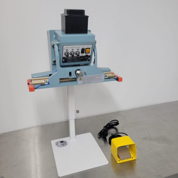 A 120v 18" 10mm Impulse Sealer Dual Element Pedal Operated and Stand is sitting on a table next to a yellow box.