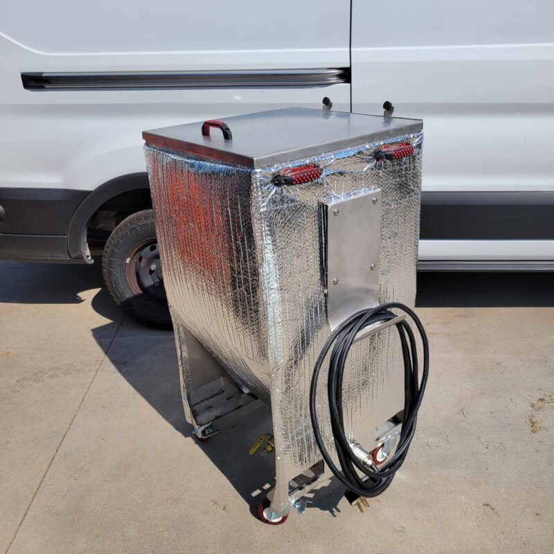 A silver Stainless Steel Grain Spawn Tank with a hose on it in front of a van.