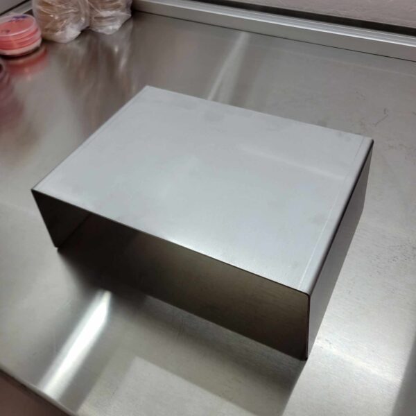 A silver box sitting on top of a Stainless Steel Raised Work Platform.