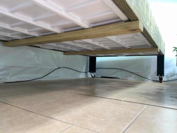 A bed under a Flood Table Corner Caster Kits in a room.