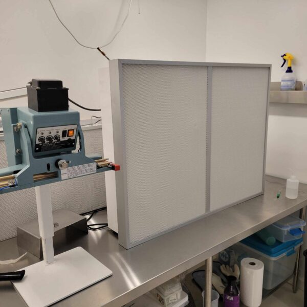 In a lab, a Pre-Order 3x4 ft Flowhood Fan Filter Unit New 120V *Freight Not Included* is placed on top of a table.